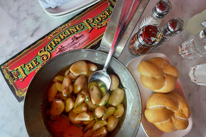 THe Stinking Rose Menu and bowl of roasted garlic